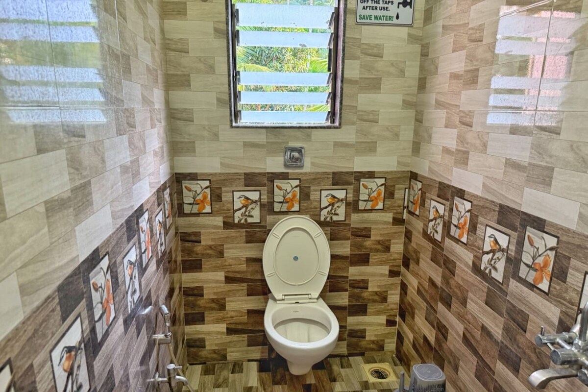 A compact bathroom with a toilet, a window, and a wall-mounted sign.