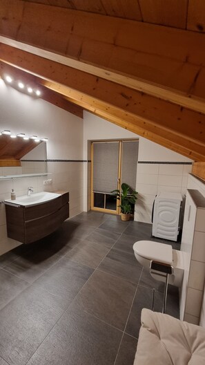 A modern bathroom with a vanity, sink, and toilet. - New Listing (Riegsee)