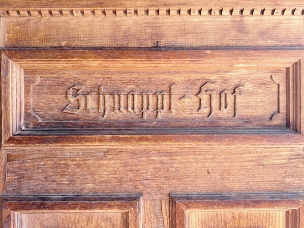 A wooden panel with carved text and geometric patterns. - New Listing (Kirchberg in Tirol)