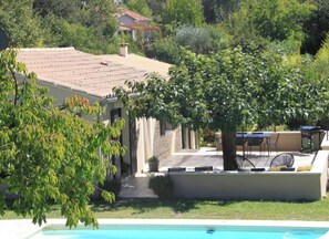 A residential property with a swimming pool, outdoor seating, and a tree. - New Listing (Goult)