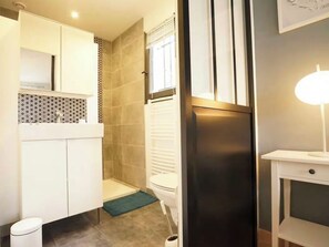 A bathroom with a toilet, a bidet, a sink, and a cabinet. - New Listing (Goult)