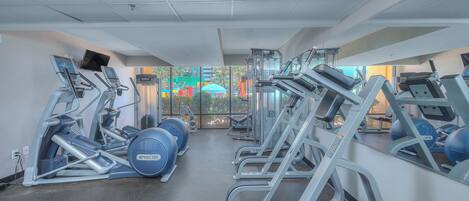 A gym with various exercise equipment, including treadmills and weight machines.