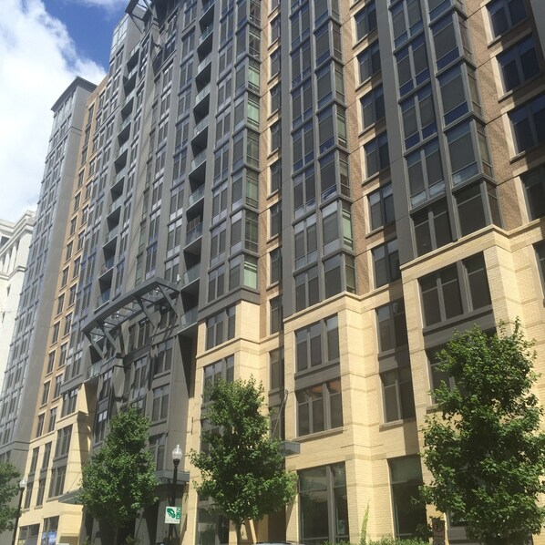 A multi-story building with a modern architectural design, featuring large windows and a mix of brick and glass facades.