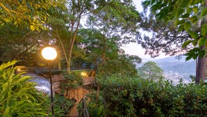 A pathway leading to a wooden deck with a view of a valley. - Santo Cielo by Casa Santo Domingo (Antigua Guatemala)
