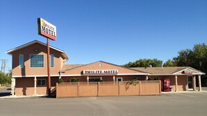 A two-story motel with a prominent sign, a fenced parking area, and a Coca-Cola vending machine. - Twilite Motel & RV Park (Prince Albert)