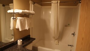 A bathroom with a sink, mirror, towel rack, and a bathtub. - Twilite Motel & RV Park (Prince Albert)