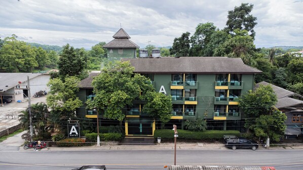 A hotel with a prominent 'A' sign, multiple balconies, and a tower-like structure on the roof. - A Hotel Budget (Chiang Saen)