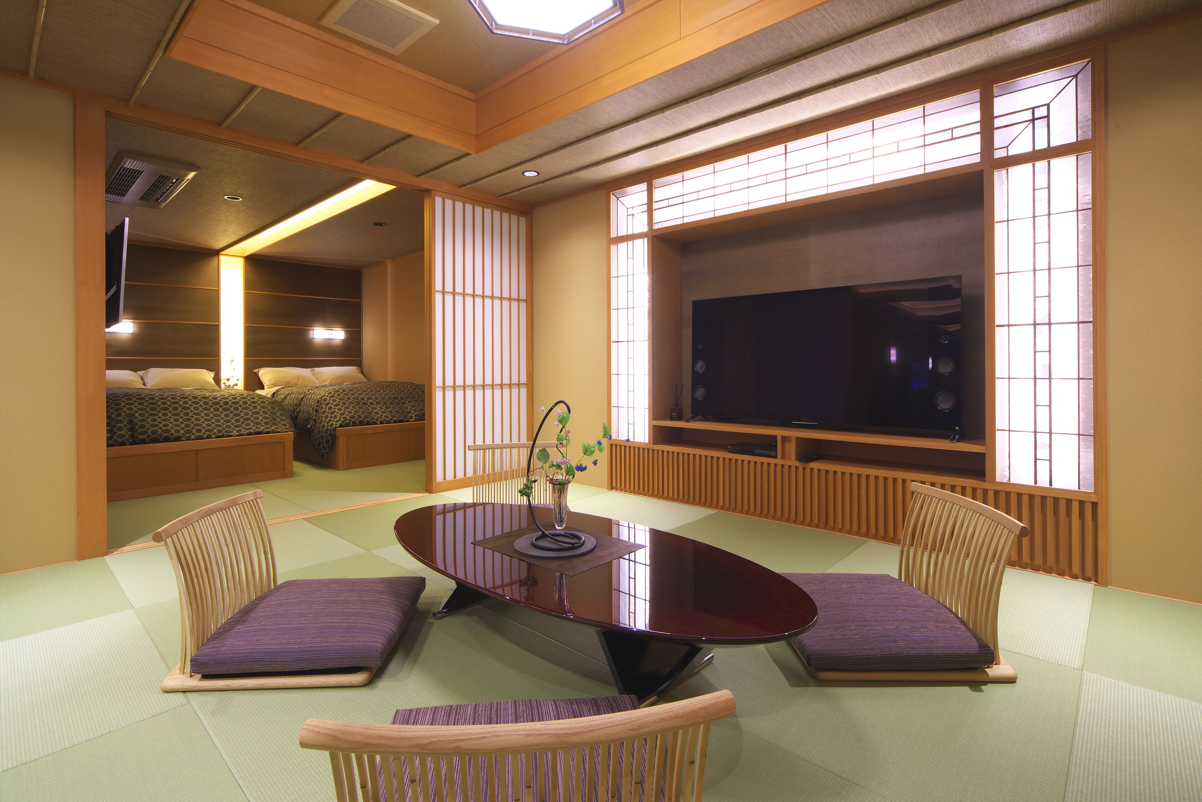 Une pièce de style japonais traditionnel, avec un sol recouvert de tatamis, une table basse et des coussins.