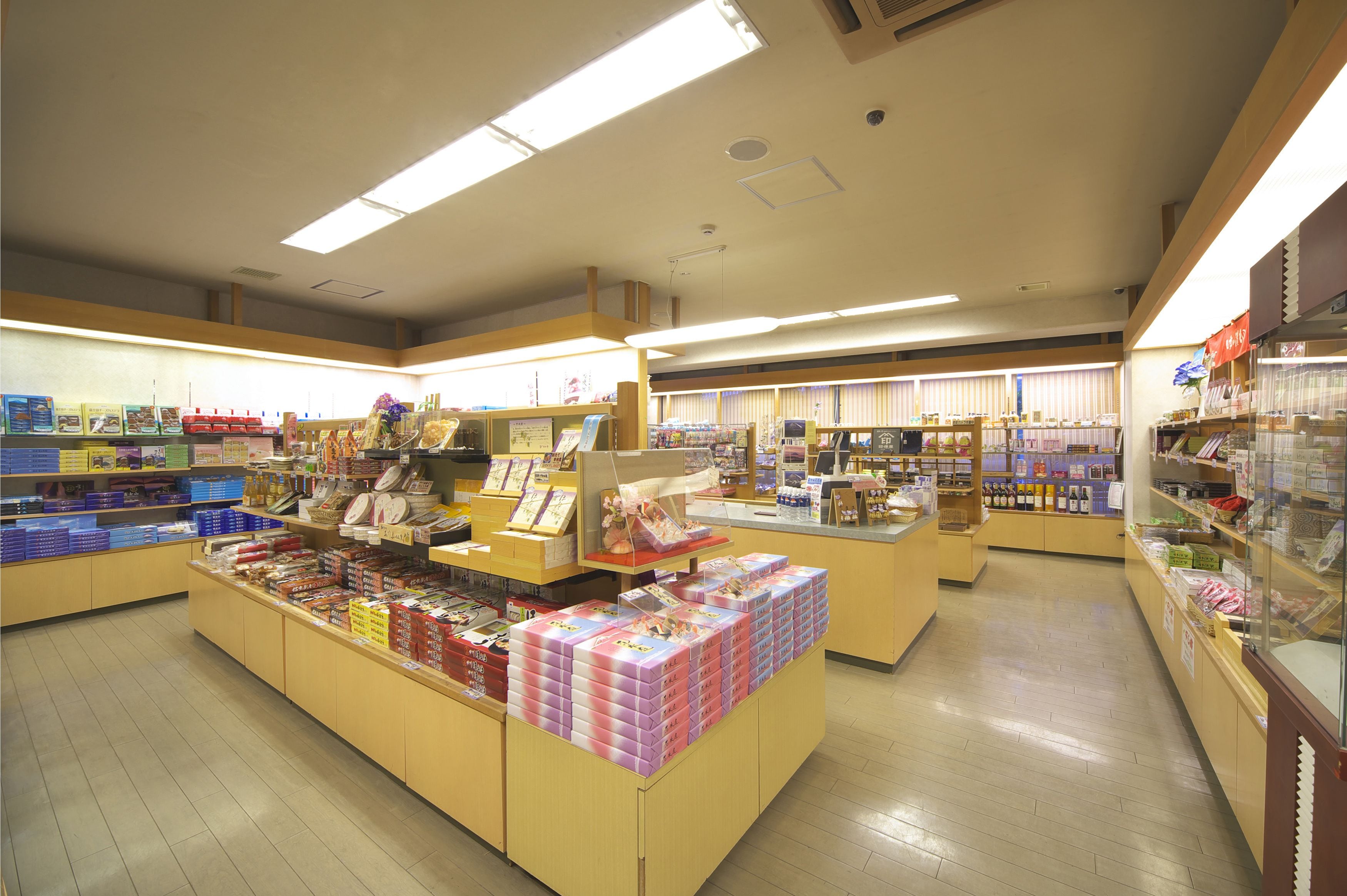 A brightly lit store with various products on shelves and counters.