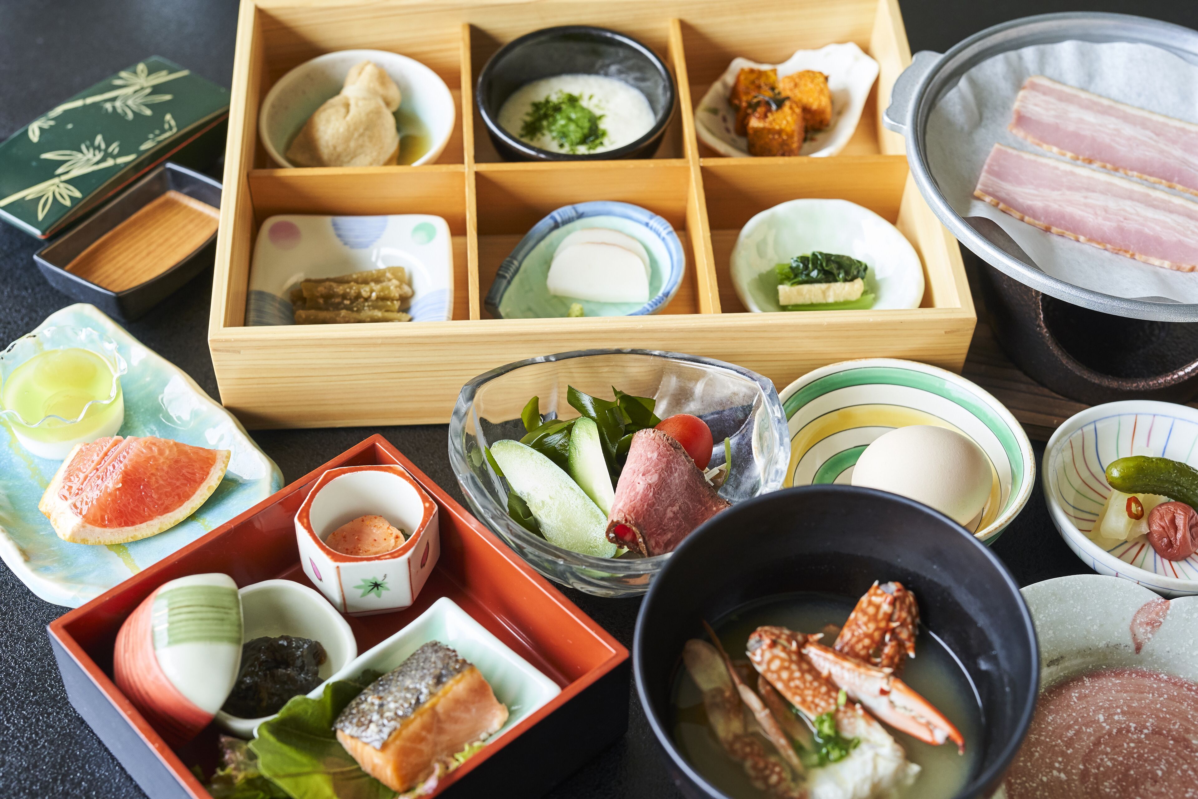 A variety of Japanese dishes arranged on a table, including sushi, sashimi, and other delicacies.