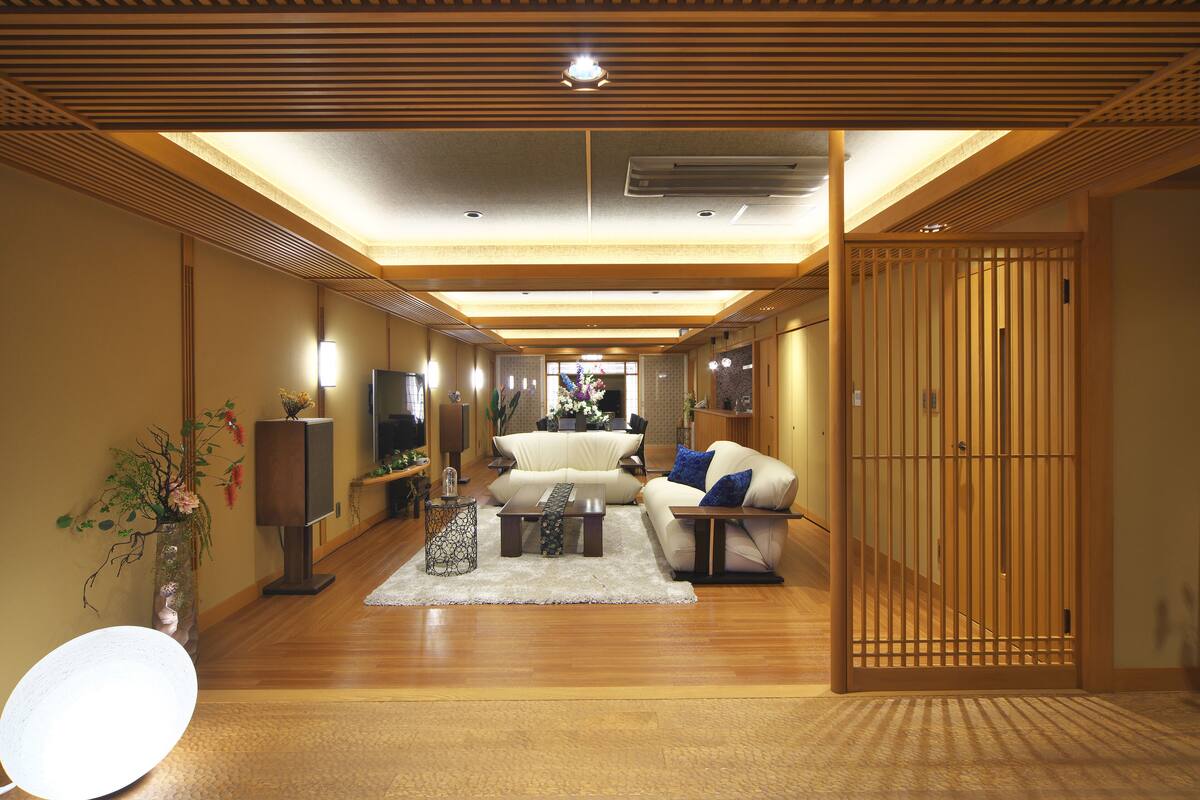 A spacious living room with a sofa, coffee table, and decorative items.