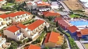 A coastal resort with multiple buildings, a swimming pool, and a view of the sea. - Lemnos Village Resort (Lemnos)