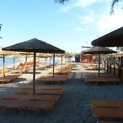 On the beach, sun-loungers, beach umbrellas, beach towels