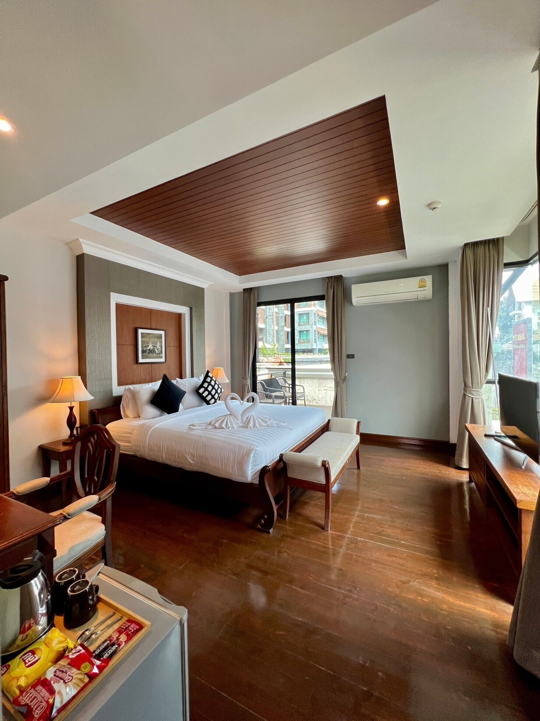 deluxe room | minibar, in-room safe, desk, iron/ironing board