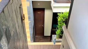 A staircase leading to a door marked with the number 103. - Yotaka Bangkok Hotel (Bangkok)