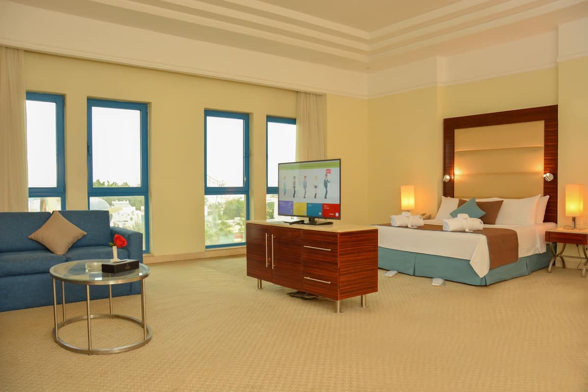 junior studio suite, city view | minibar, in-room safe, desk, blackout curtains