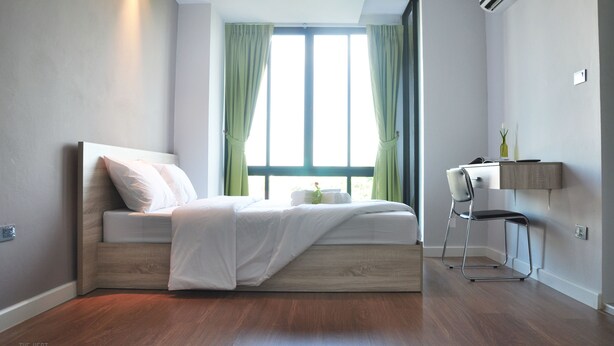 A modern bedroom with a bed, a desk, and a chair. - The Vert Apartment (Bangkok)