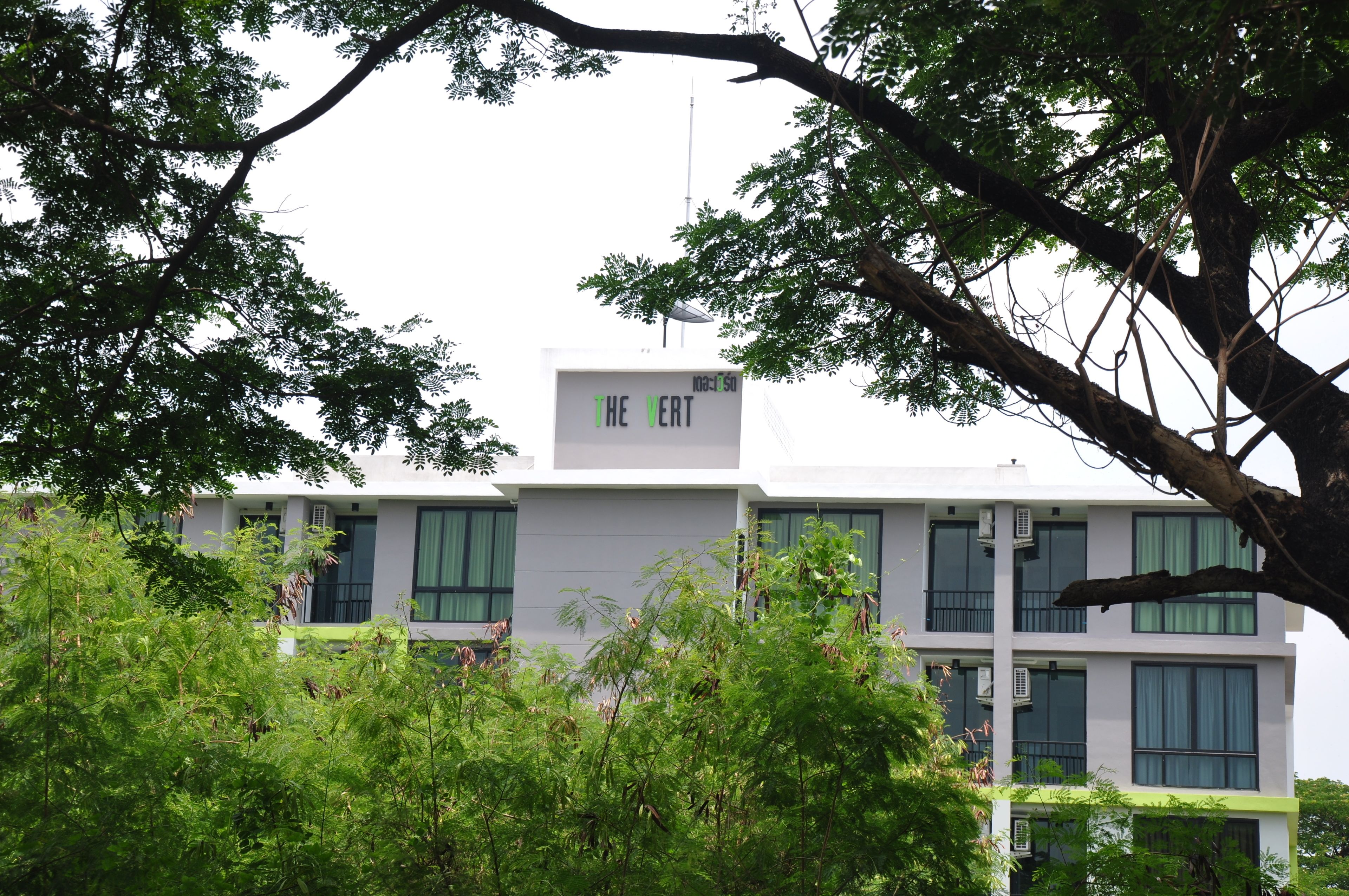 A modern building with a sign reading "THE VERT" on the facade.