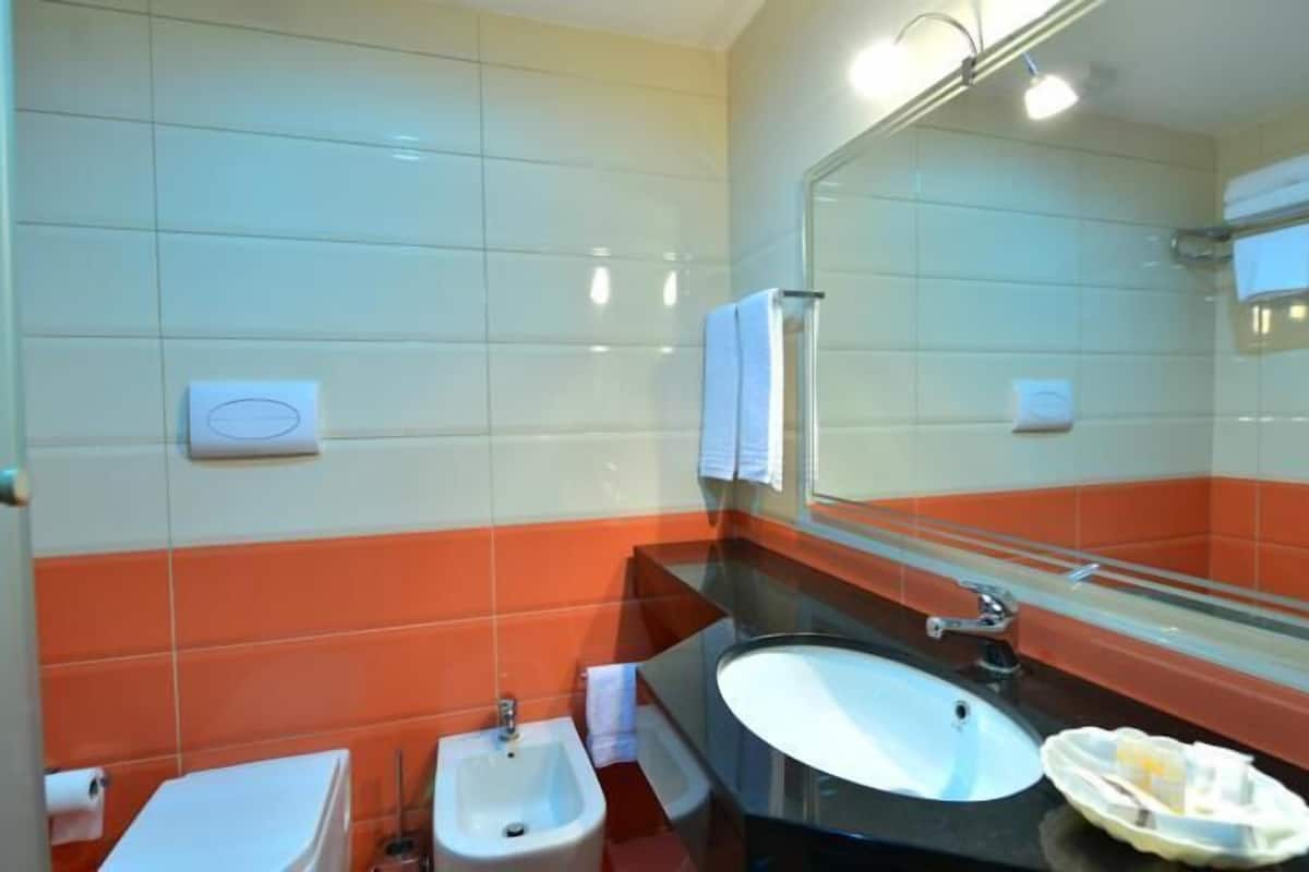 superior twin room | bathroom | shower, free toiletries, slippers, bidet
