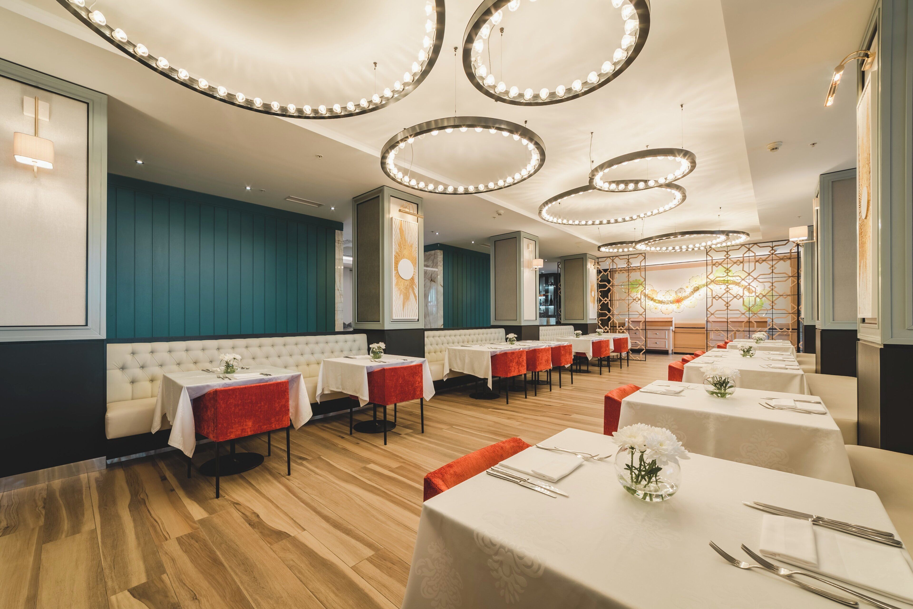 A restaurant with multiple tables, booths, and a decorative ceiling.