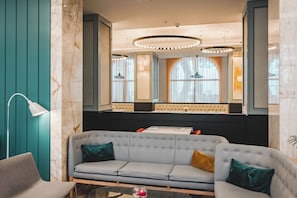 A modern interior with a sofa, a lamp, and a mirror.
