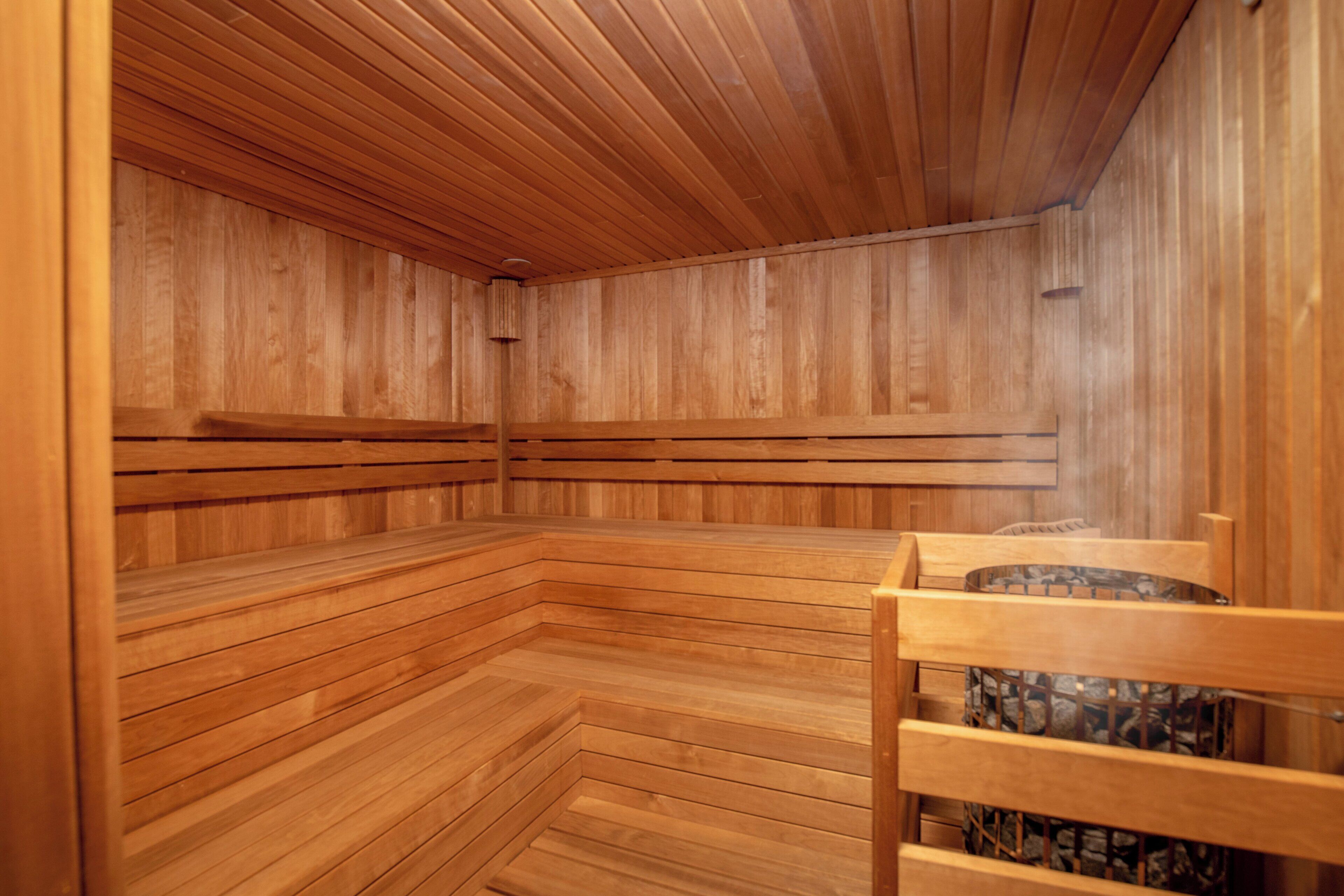 A sauna with wooden benches and a wooden ceiling.