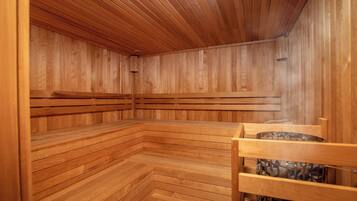 A sauna with wooden benches and a wooden ceiling.
