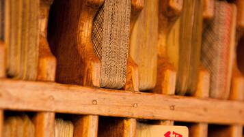 A wooden rack with a playing card inserted into it.