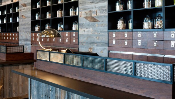 A storage area with metal shelves and wooden cabinets, containing various items.
