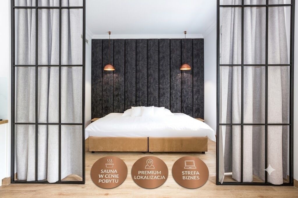 A bedroom with a bed, curtains, and a headboard.