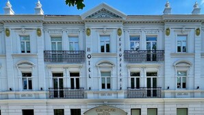 A historic building with a classic European architectural style, featuring a symmetrical facade, ornate balconies, and a prominent entrance labeled "EUROPEJSKI HOTEL." - Europejski Boutique Hotel (Radom)
