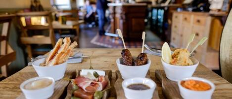 A wooden table with various food items and condiments.