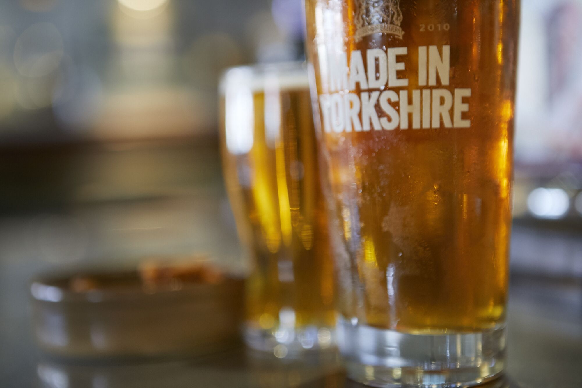A close-up of a glass with the text "MADE IN YORKSHIRE" on it.