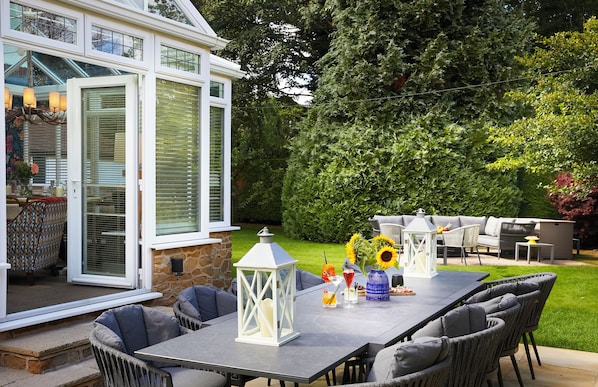 An outdoor patio with a dining table, chairs, and a decorative lantern. - The Plough Scalby (Scarborough)