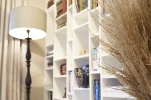 A bookshelf with books and decorative plants.