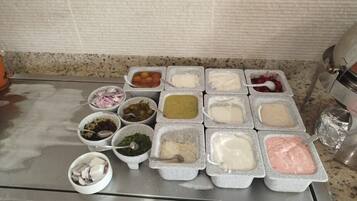 A kitchen counter with various food items and containers.
