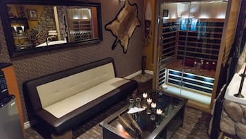 Upgraded hot tub suite with tornado steam shower, infared sauna, and fireplace | Living area | LCD TV, fireplace, pay movies