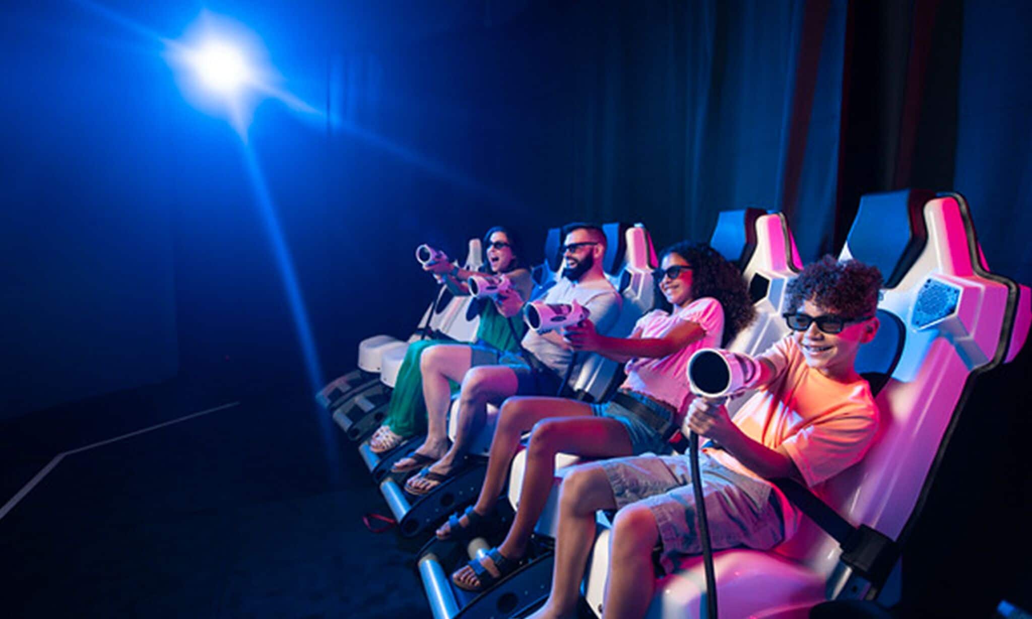 A row of seats in a theater with a blue light overhead.