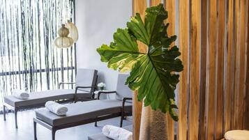 Relax in a serene space with a large planter, wooden slat wall, and cozy seating area.