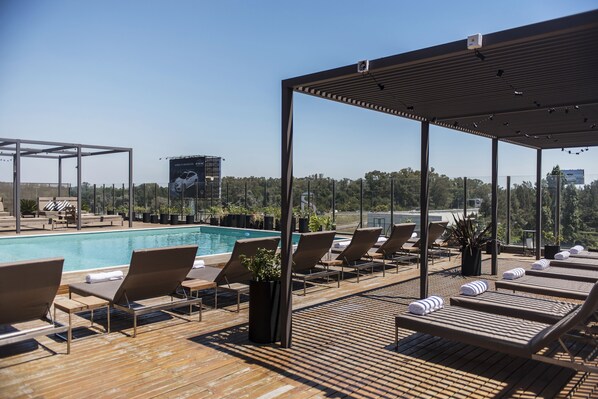 Outdoor pool, open 9:00 AM to 8:00 PM, pool umbrellas, pool loungers