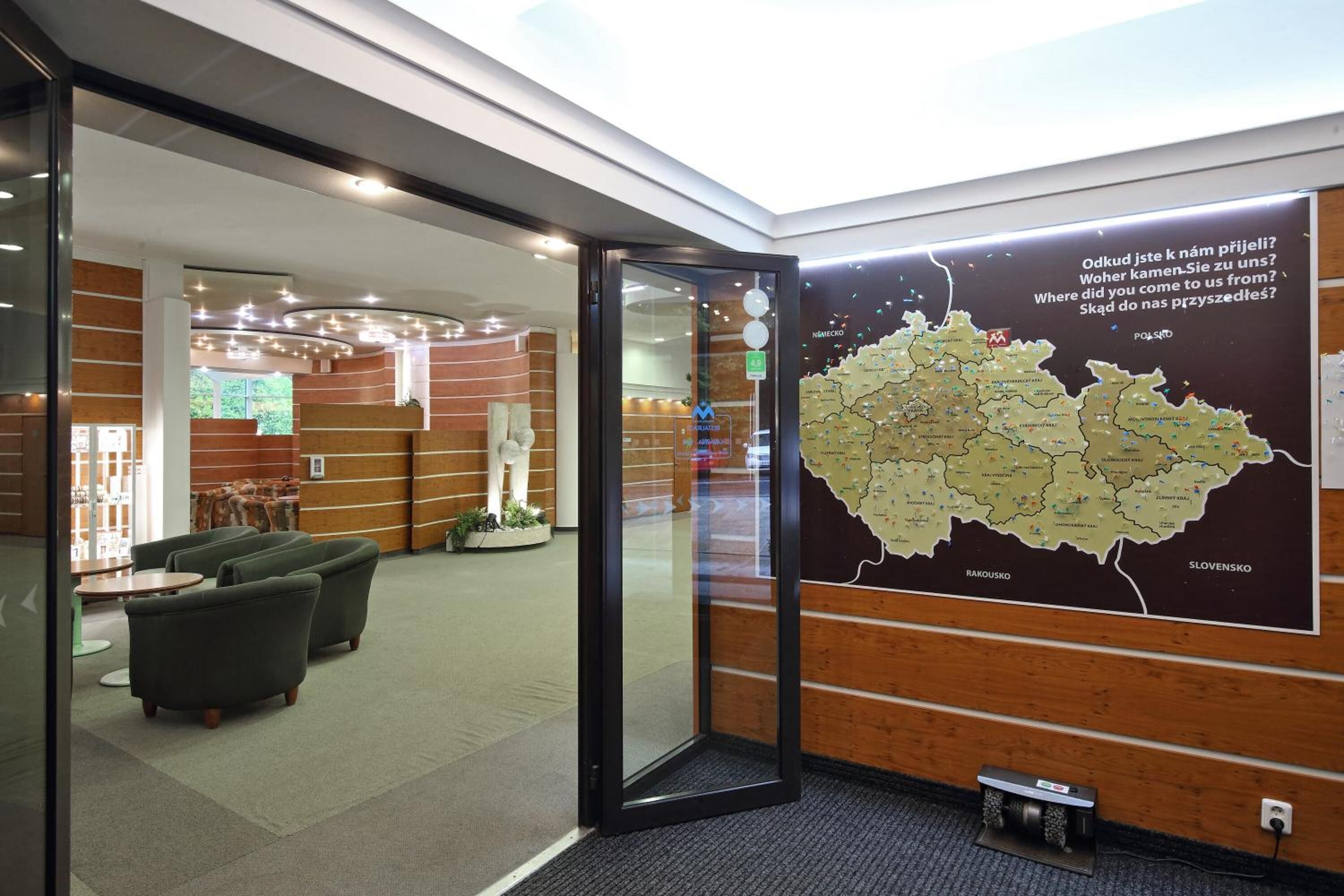 A lobby with a map of Poland, seating areas, and a reception desk.