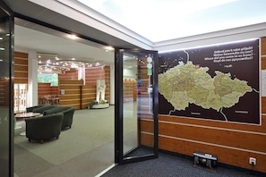 A lobby with a map of Poland, seating areas, and a reception desk. - Interhotel Montana (Spindleruv Mlyn)
