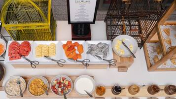 A breakfast buffet with various food items and condiments.