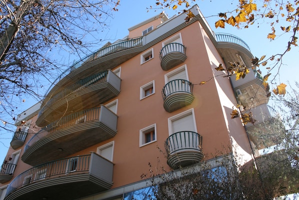 A multi-story building with balconies and windows.