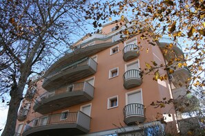 A multi-story building with balconies and windows.