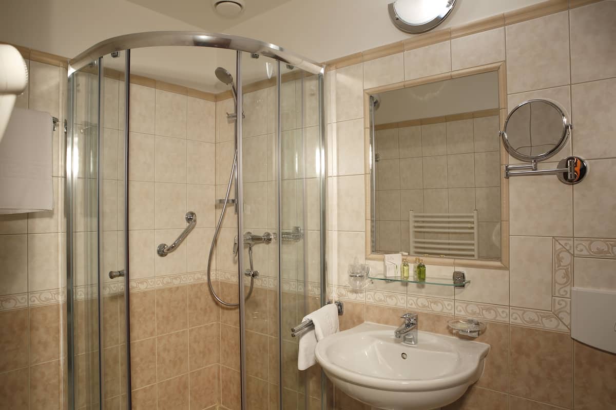 standard single room | bathroom | bathtub, designer toiletries, hair dryer, bathrobes