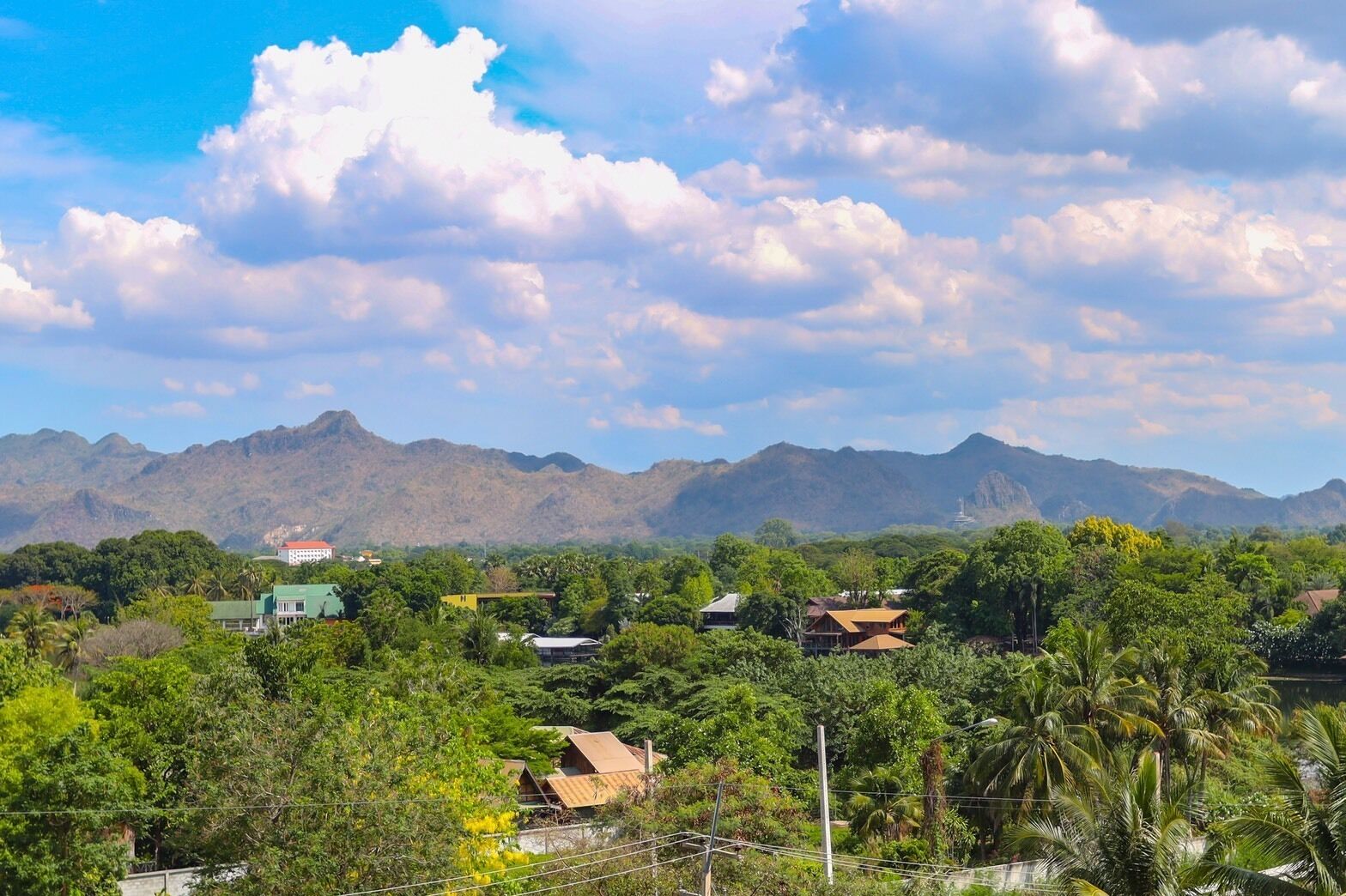 A mountainous landscape with scattered houses and lush greenery.