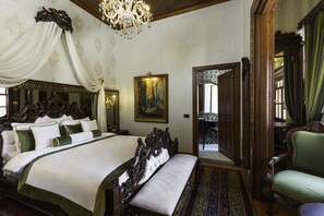 A large, ornate bed with a canopy, a chandelier, and a painting on the wall. - Hotel 1207 Special Class (Antalya)