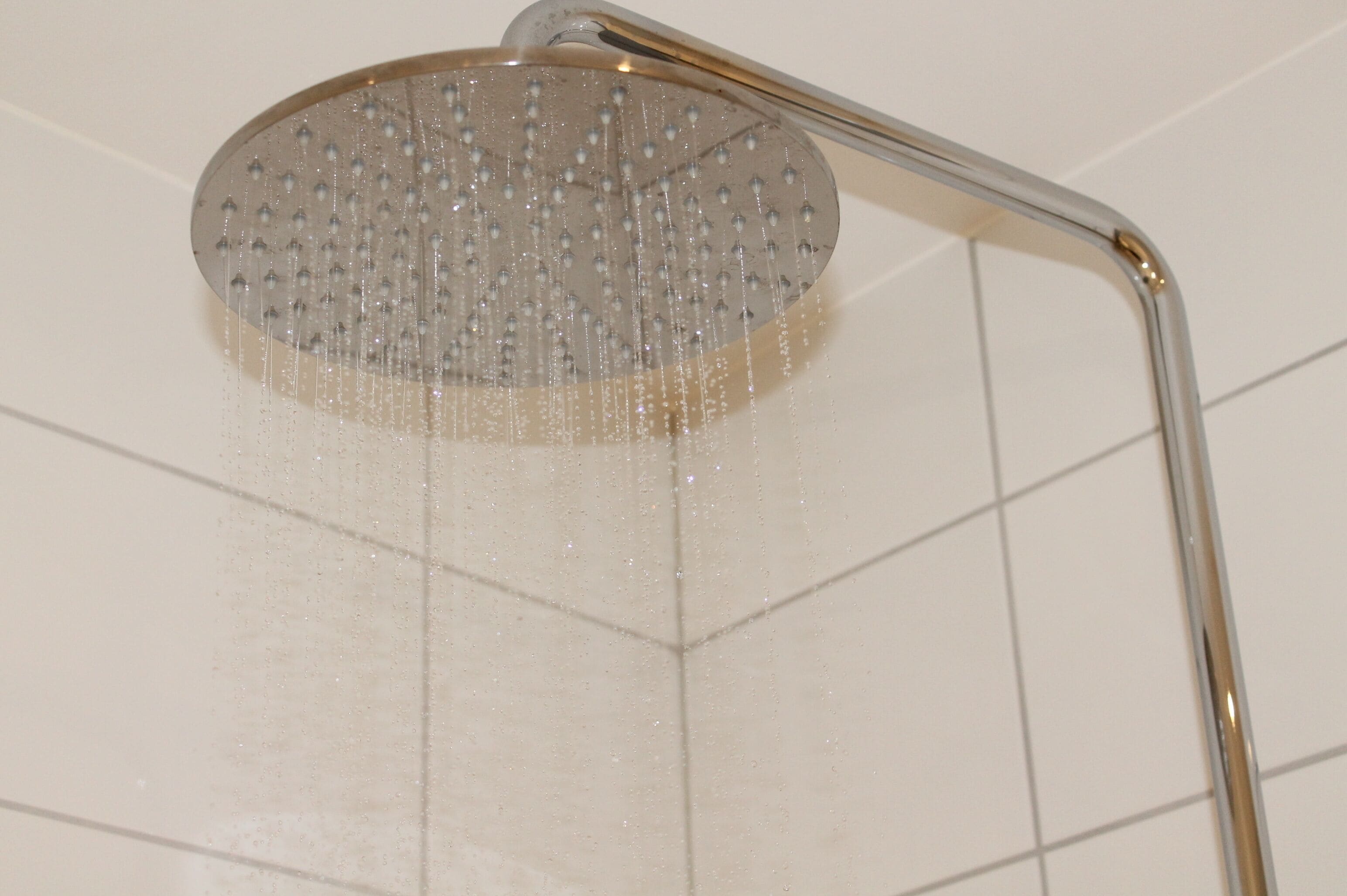 A showerhead with water running.