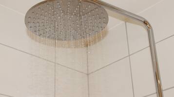 A showerhead with water running.